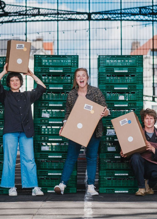the solid stash team posing with shipping boxes