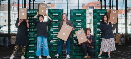 the solid stash team posing with shipping boxes